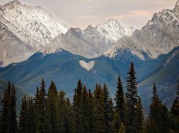 A natural heart shape in the snow peaked Rocky Mountains British Columbia Canada.  Photo taken at sunset