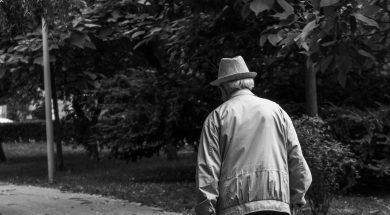 grayscale-back-view-photo-of-elderly-man-with-cane-walking-2586537