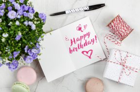 happy-birthday-card-beside-flower-thread-box-and-macaroons-2072181
