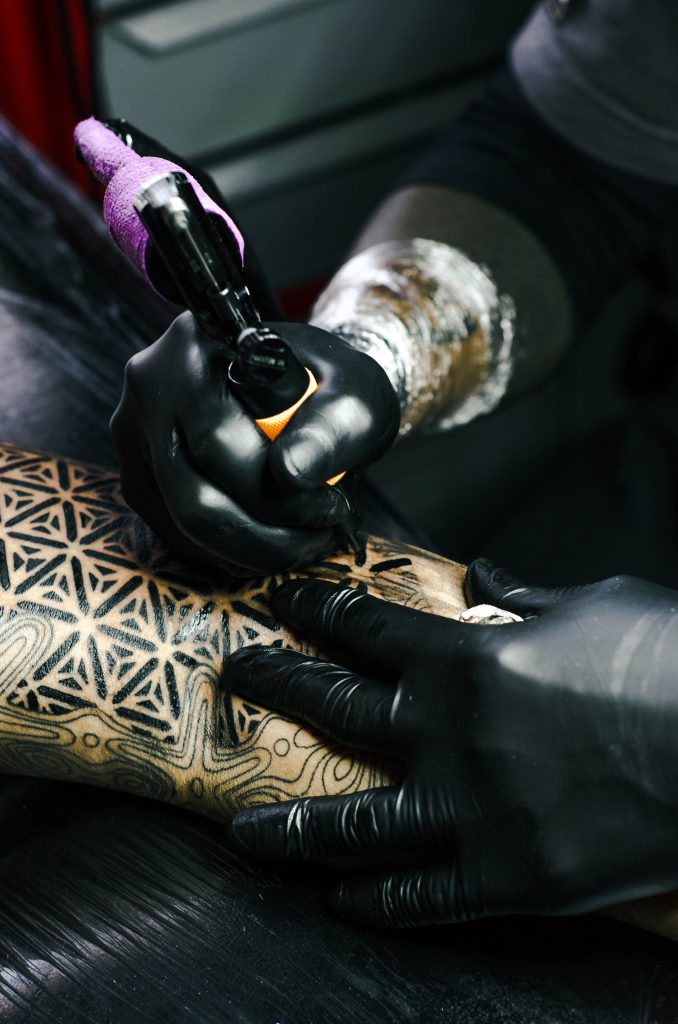 selective-focus-photography-of-tattoo-artist-drawing-a-tatoo-1304469