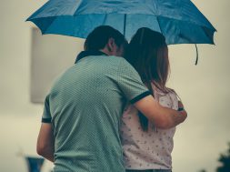 man-hugging-woman-while-holding-umbrella-1534633