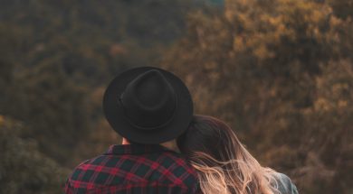 couple-standing-on-top-of-hill-1995718