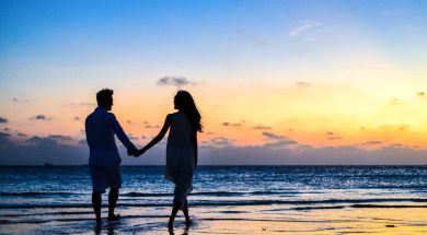man-and-woman-holding-hands-walking-on-seashore-during-1024960