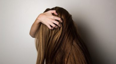 photo-of-woman-covering-face-with-her-hair-1159334