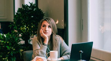 woman-in-gray-sweater-sitting-on-chair-in-front-of-laptop-3681622