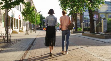 photo-of-women-walking-down-the-street-1116984