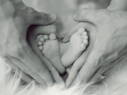 grayscale-photo-of-baby-feet-with-father-and-mother-hands-in-733881 (1)