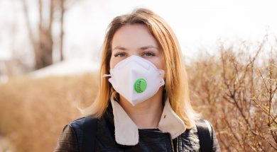 Young woman in a protective mask is walking. Coronavirus Protection Concept