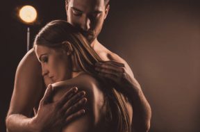 tender boyfriend hugging naked boyfriend, on brown with back light