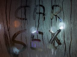 the words car sex written by finger on sweaty night window glass - close-up in horizontal orientation