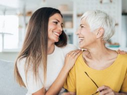 Modern senior woman and her adult daughter happy together