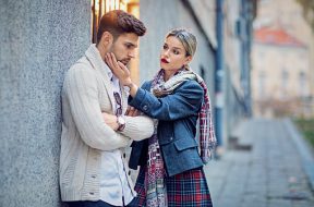 Woman is consoling her sulking boyfriend on the street