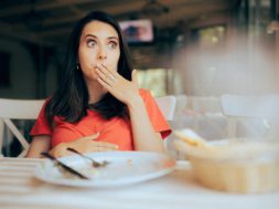 Restaurant customer regretting overeating decisions