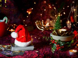 Blurred Tarot cards on table near burning candles. Tarot reader or Fortune teller reading on Christmas decoration