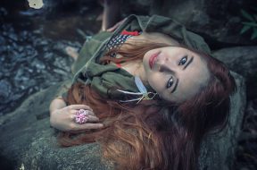 Asia beautiful young sexy girl lying down on a rock in water fall