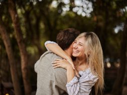 Carefree woman enjoying while embracing her boyfriend in spring day.