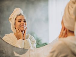 Woman at home applying cream mask